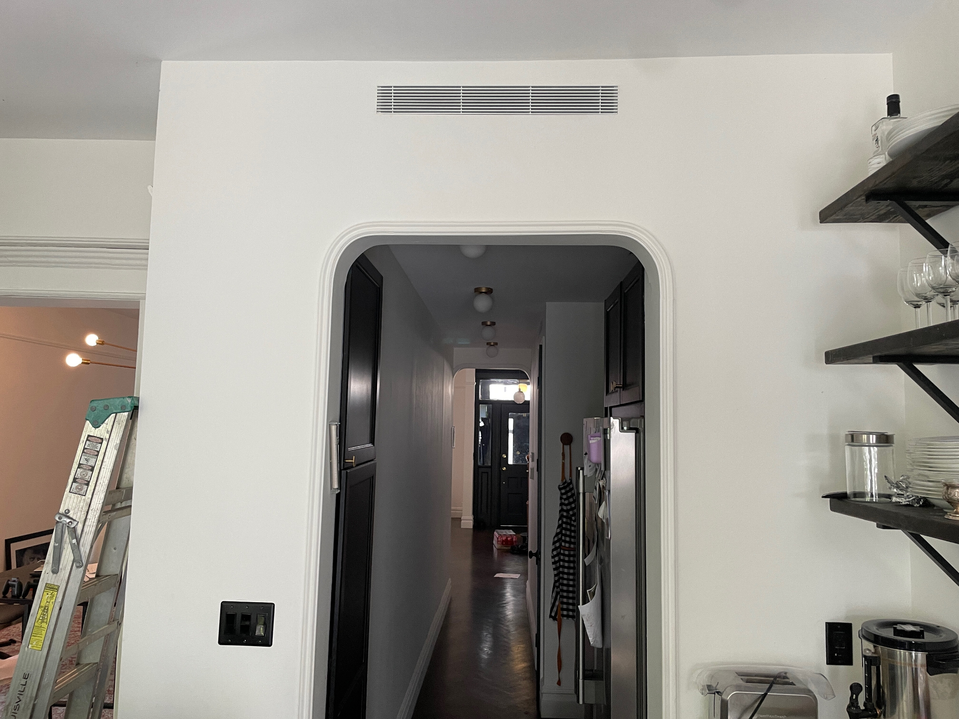 Linear grille above arched opening